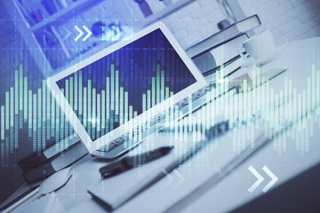 Stock market chart hologram drawn on personal computer background. Double exposure. Concept of investment.