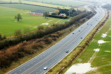 Aerial view of the M11 motorway running through the farmland of Cambridgeshire