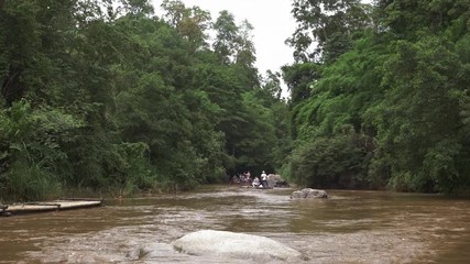 A group of unidentifiable tourists taking a river boat ride in Chiang Mai, Thailand.
