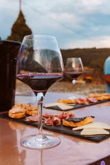 Detail of table with appetizer and red wine tasting on a traditional countryside experience.
