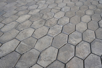 Paving slabs as a gray abstract background. Street hexagonal cobblestone sidewalk. Abstract background for design.