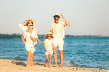 Happy family on sea beach at resort