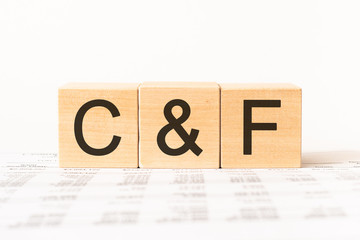Word C&F, Cost and Freight. Wooden small cubes with letters isolated on white background with copy space available