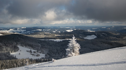 Fototapeta na wymiar White winter mountain landscape. focus on mountains in the background.