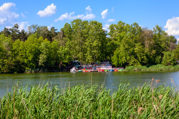 Amusement park on the lake . Berth wit Pleasure Boats