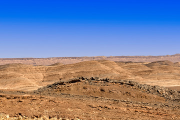 View of the Ramon crater colorful mountains with traces of geological events. Negev desert. Israel