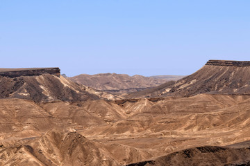 Fototapeta na wymiar View of the Ramon crater colorful mountains with traces of geological events. Negev desert. Israel