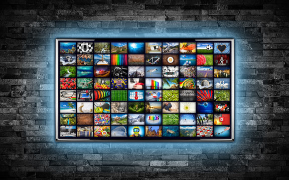 black flat tv screen display with picture movie gallery backdrop. television wall mounted  dark slate stone wall glowing blue LED background. Multimedia streaming internet cloud concept