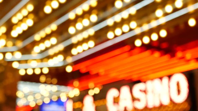 Defocused old fasioned electric lamps glowing at night. Abstract close up of blurred retro casino decoration shimmering, Las Vegas USA. Illuminated vintage style bulbs glittering on Freemont street.