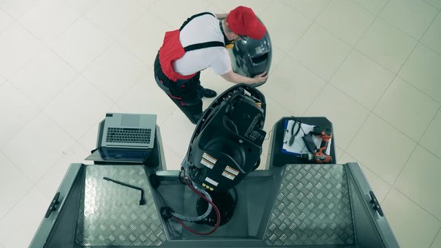 Technician is preparing to repair sailboat's engine