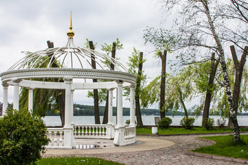 White gazebo on an island in the middle of a lake in Ternopil. Ukraine