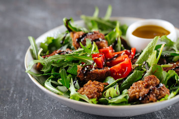 Gourmet salad with fried meat and greens