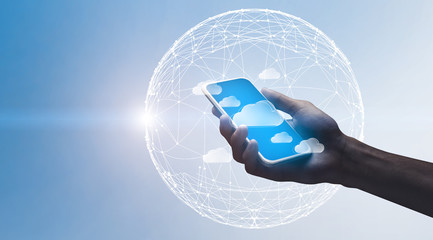 Cloud Computing. Hand holding smartphone with flying data storage cloud icons