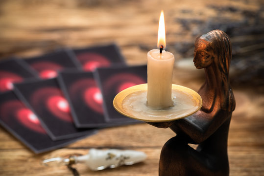 Tarot cards on the old wooden table background.