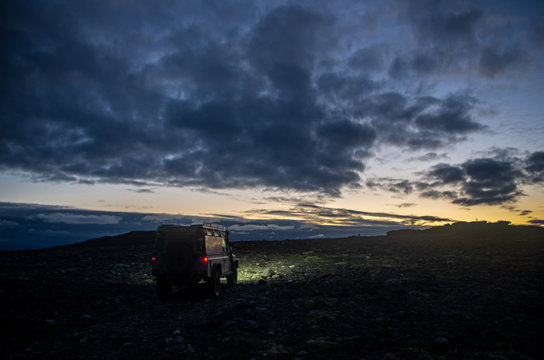 a car in the mountains after sunsent