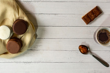 coffee cup on wooden table and chocolate