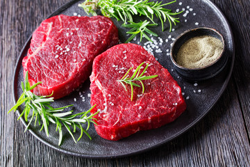 dry-aged beef steaks on a black plate