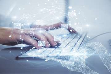 Envelop holograms with businessman working on computer on background. E-mail concept. Multi exposure.