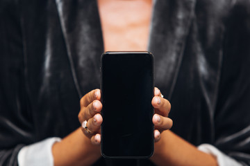Woman is holding smartphone close up