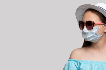 Quarantine prevention. COVID-19 protection. Woman saved by medicine mask isolated on gray copy...