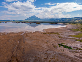 Aerial view on a Picturesque Coastline of Lake Natron in the Great Rift Valley, between Kenya and Tanzania. In the dry season the lake is 80% covered by soda and is known for its wading birds and huge