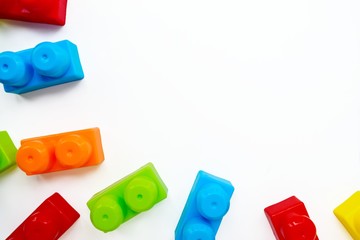 Scattered bright multi-colored children's designer on a white background. Childhood. Useful and interesting games.