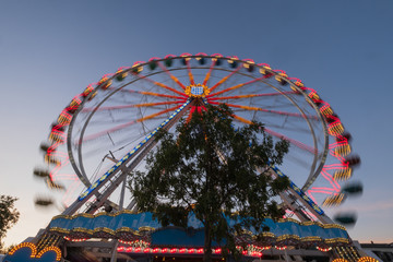 Ferris wheel in motion in the evening on the banks of the Rhine near Eltville / Germany