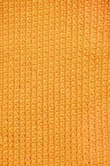 Orange knitted fabric texture background. Top view. Copy, empty space for text