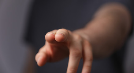 Obraz premium A man hand touching virtual screen, modern background concept , can put your text at the finger, copy space.