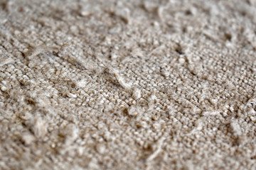 Old dirty carpet or rug with cat scratches.  Selective focus.  