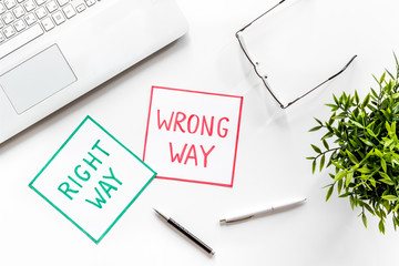 Doubt concept.. Right and wrong way icons on work desk from above