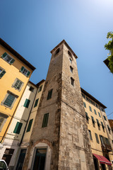 Fototapeta na wymiar Torre del Campano (tower of the bell, Italian) , XII Century, medieval bell tower in Pisa downtown, in Via Domenico Cavalca. Tuscany, Italy, Europe