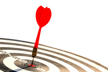 Target hit in the center by arrow. Success goals Targeting the business concept. Close up shot red dart arrow on center of dartboard, isolated on white background with clipping path.