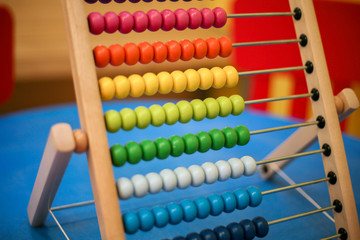 close-up of children's scores of different colors on a blue surface.