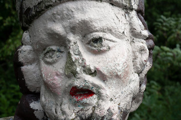 Old and aged statue of Jan Nepomucky / John of Nepomuk. Sculpture is ruined, shabby and...