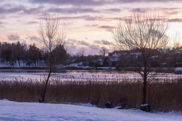Beautiful winter landscape with coast of Luka lake in Trakai, Lithuania in evening time.