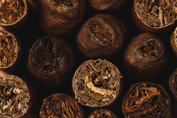 Pile of new cigars close up on wooden table