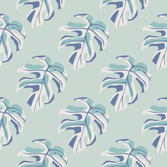 Monstera leaves silhouette seamless pattern. Exotic branches and background in light blue palette.