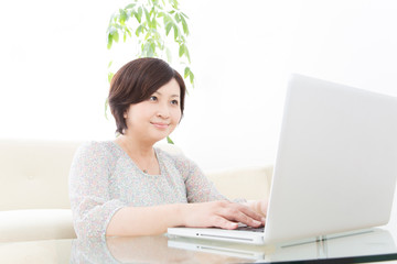 Fototapeta premium ノートパソコンをするミドル女性
