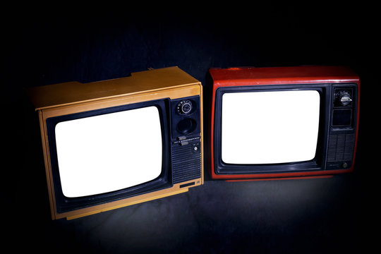 Two Vintage Old TVs With Cut Out Screen In A Room With A Dark Background