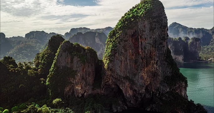 Aerial drone hyperlapse timelapse of beautiful tropical coast with rocks and cliffs. The camera moves and the surrounding life turns into a toy world. Lifestyle clip or background for presentation.