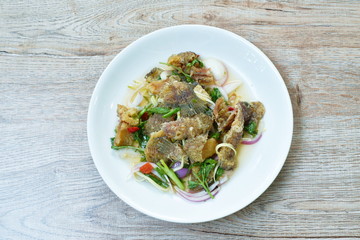 deep fried slice snake skin gourami spicy and sour Thai salad on dish