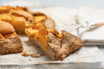 Peach cake, pie, blue background with a fork . Close-up View