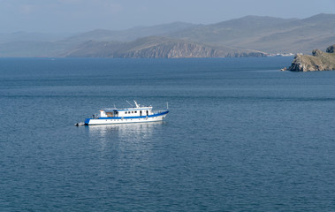 the small vessel on a large lake. Sunny day.