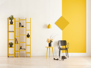 Decorative yellow and white wall concept, bookshelf and black chair.
