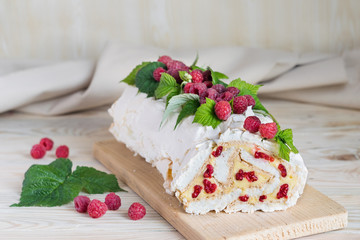 Meringue roll cake with cream and fresh raspberries. Roulade, summer dessert. Selective focus,...