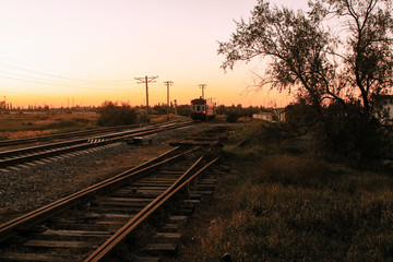 Obraz premium The train goes off into the distance. Evening in Dzhankoy, Crimea