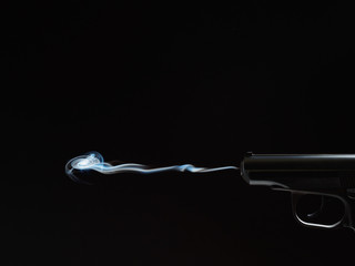 black silhouette of a gun with smoke
