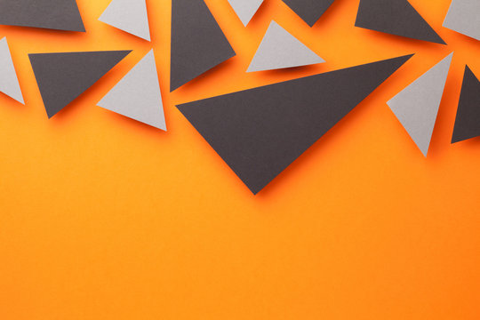 Black And Gray Triangular Shapes On Orange - Powered by Adobe