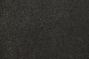 Black background that fills the whole picture. Shredded black rubber